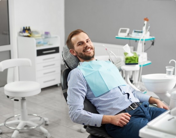 Man smiling in comfortable dental office treatment room