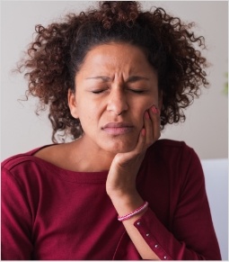 Woman experiencing jaw pain before T M J treatment