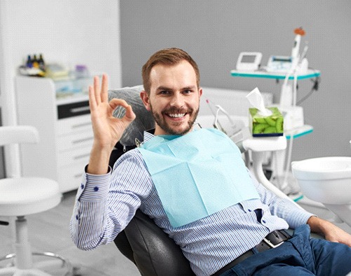 Male dental patient giving the okay sign