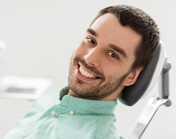 Patient smiling while sitting in treatment chair