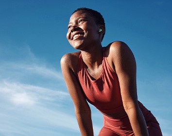 Woman smiling while exercising outside