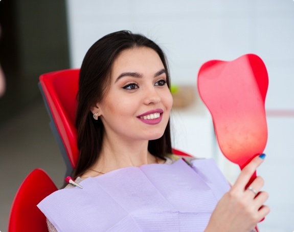 Woman looking at smile after virtual smile design