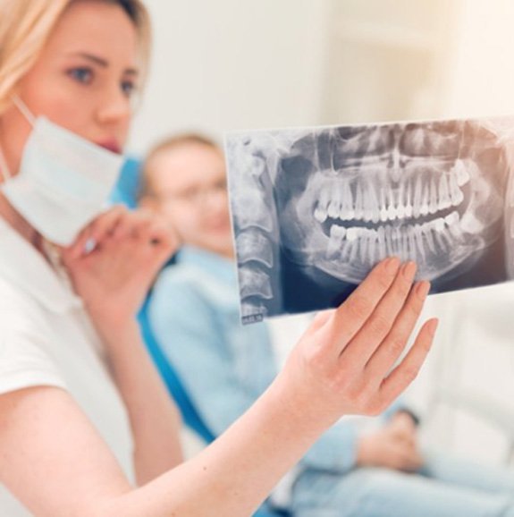 Dentist showing a patient their dental X-ray 