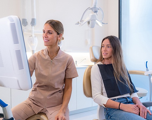 Dentist and patient looking at computer together