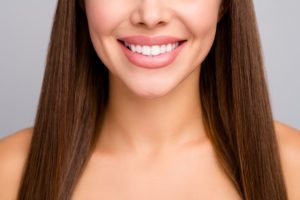 Nose down view of woman with brown hair smiling