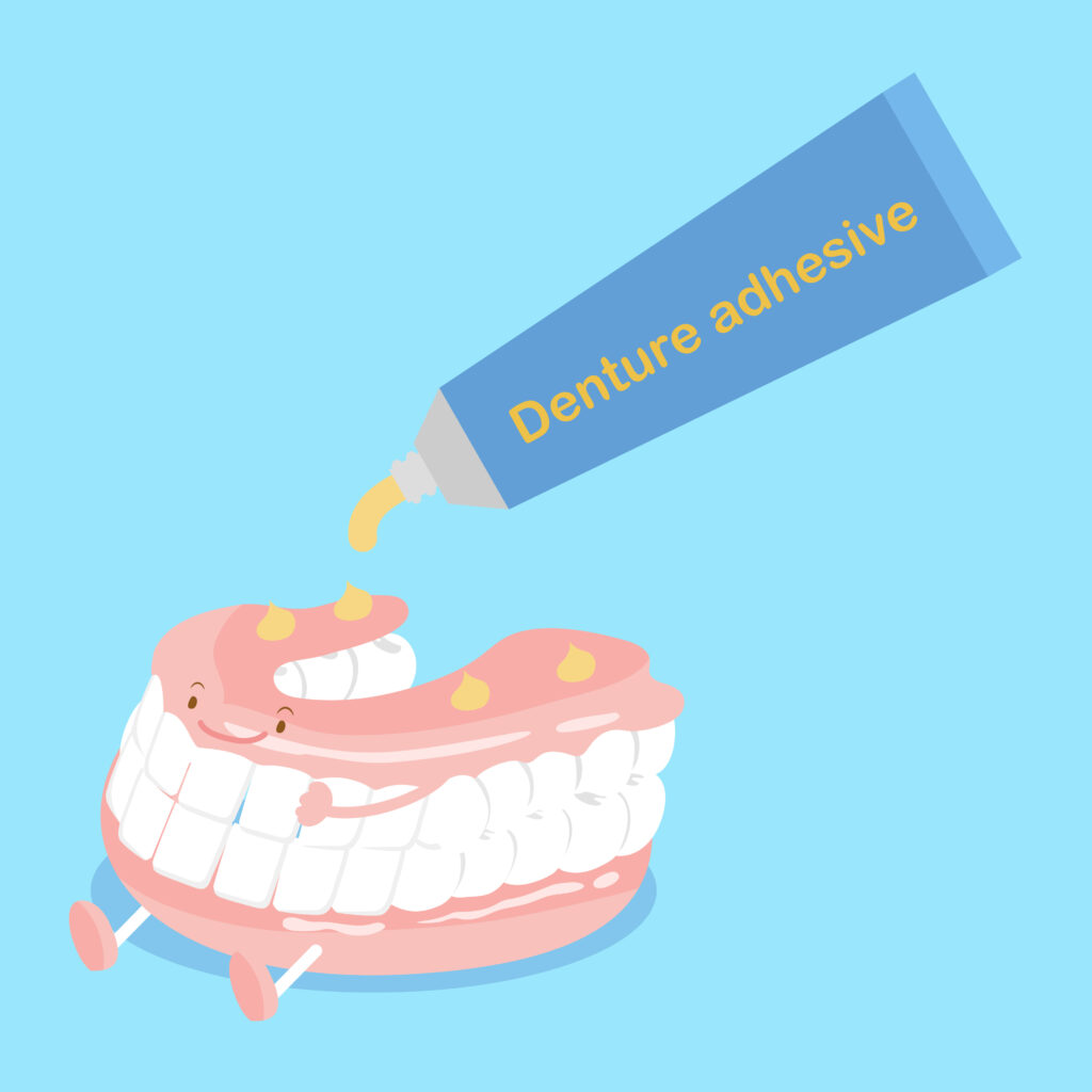 A cartoon drawing of a denture and denture adhesive